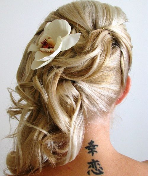 side wedding hairstyle with a flower