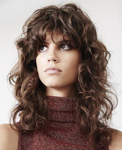 long curly shag hairstyle with bangs