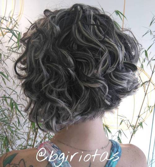 curly short black bob with blonde highlights