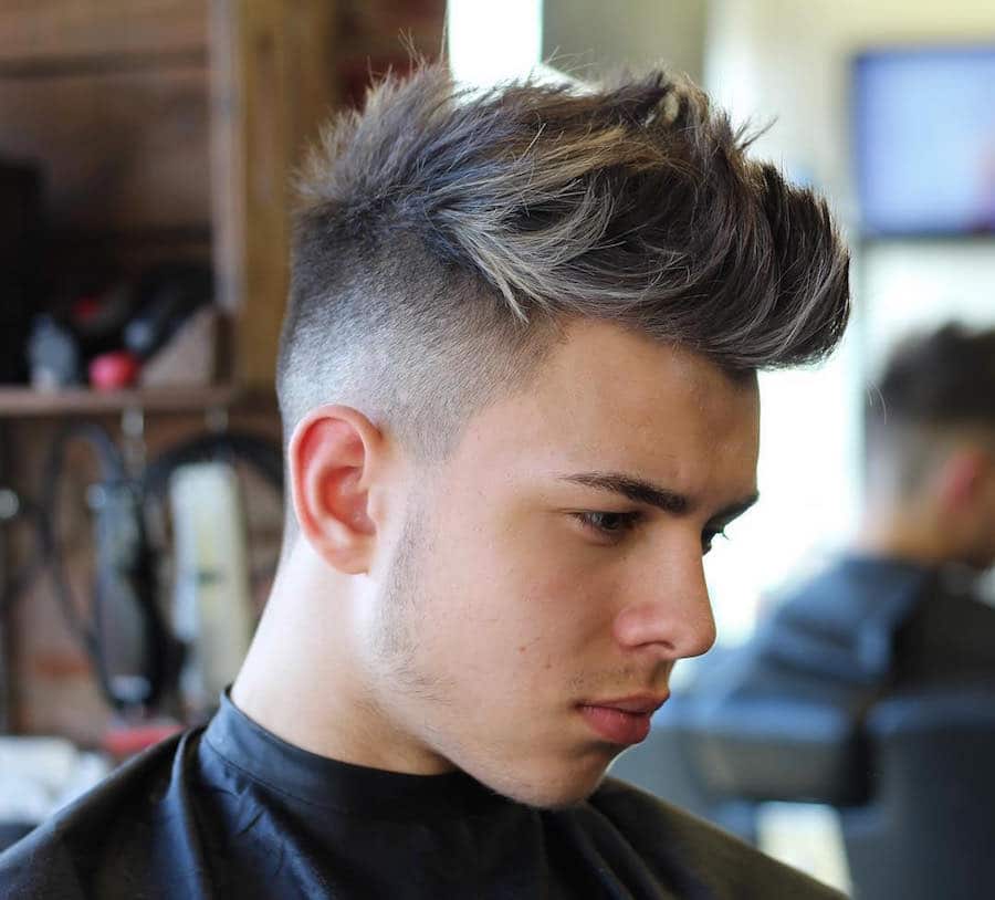 Quiff haircut for men with textured hair and high fade