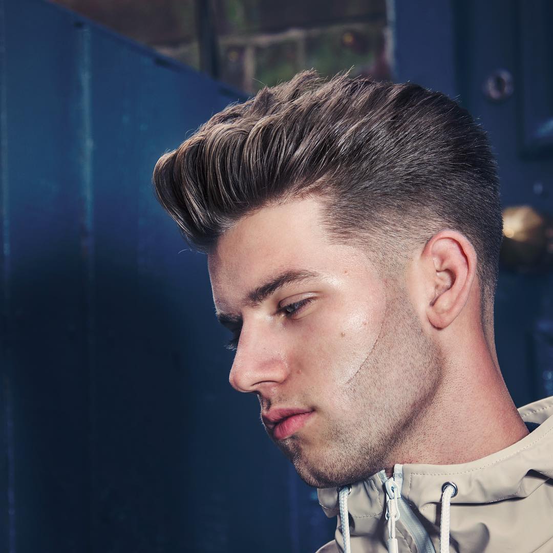 Short textured mens haircut with a mid fade