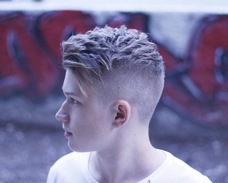 Short textured haircut for men with high fade