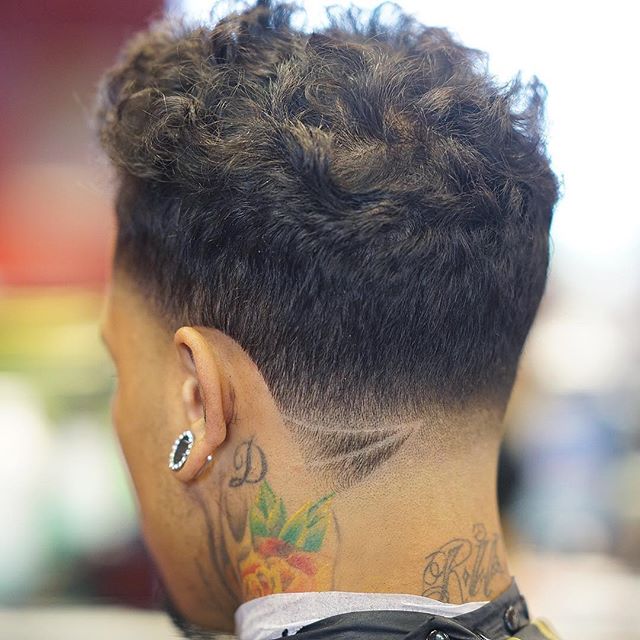 Cool mens haircut for curly hair with a low fade