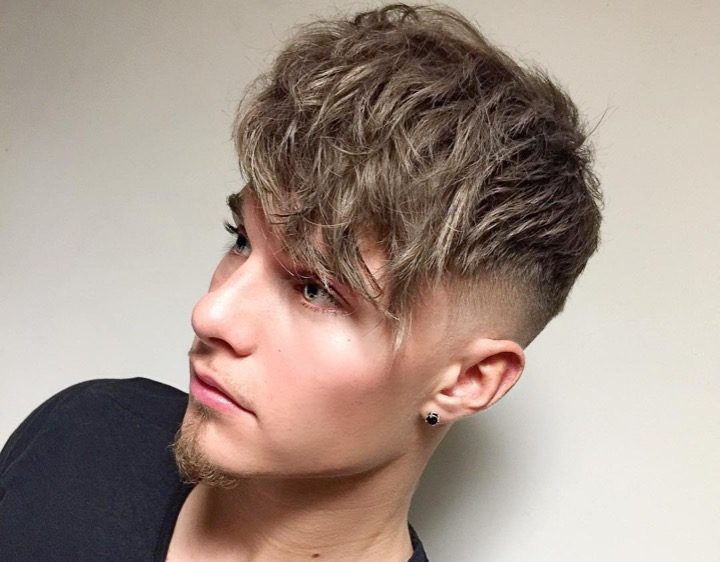 Long textured fringe mens hairstyle with a mid fade