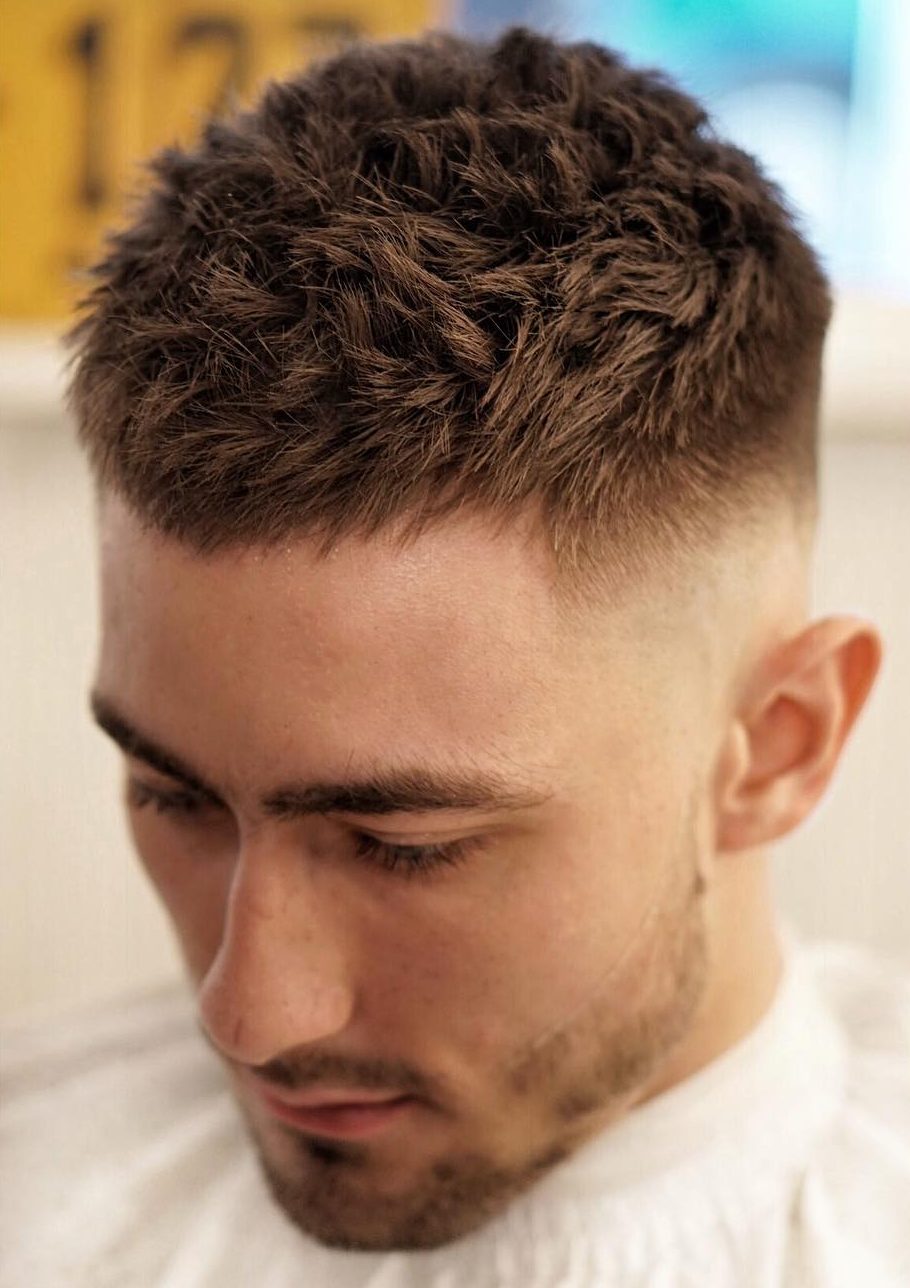 Corte de cabelo curto para homens com texturas espetadas e alto desbotamento