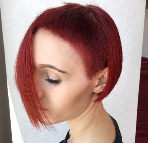 asymmetrical red bob with extra short bangs