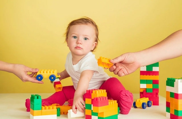 petite fille jouant avec des blocs de jouets