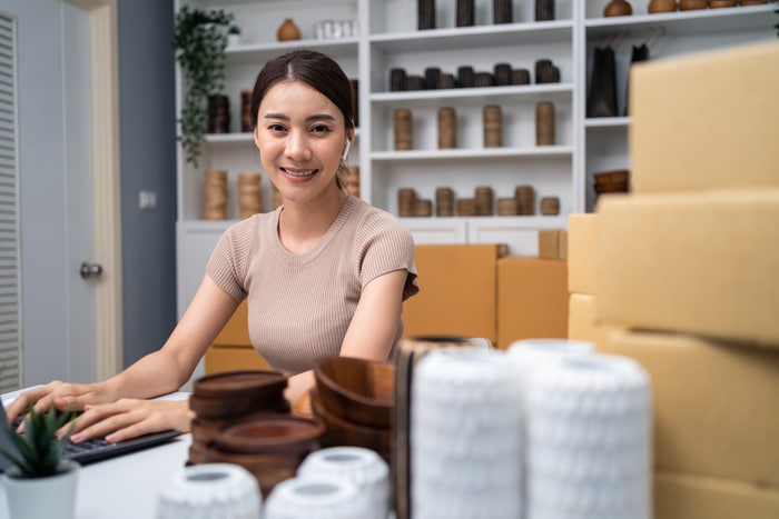 portrait de femme asiatique vendre vase produit en ligne branding promotion publicité marque