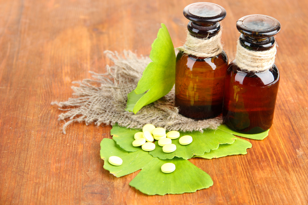 Ginkgo biloba en comprimés sur feuilles fraîches, plante stimulant la circulation sanguine cérébrale pour améliorer la concentration