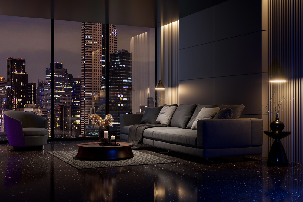 Salon design en soirée avec vue sur la ville, alliance entre modernité, confort et ambiance tamisée